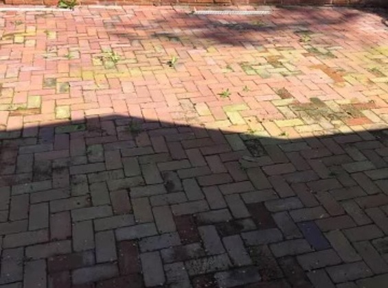 Linked image of residential brick patio before restoration