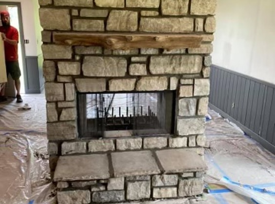 Linked closeup image of Stone Fireplace installation with insert